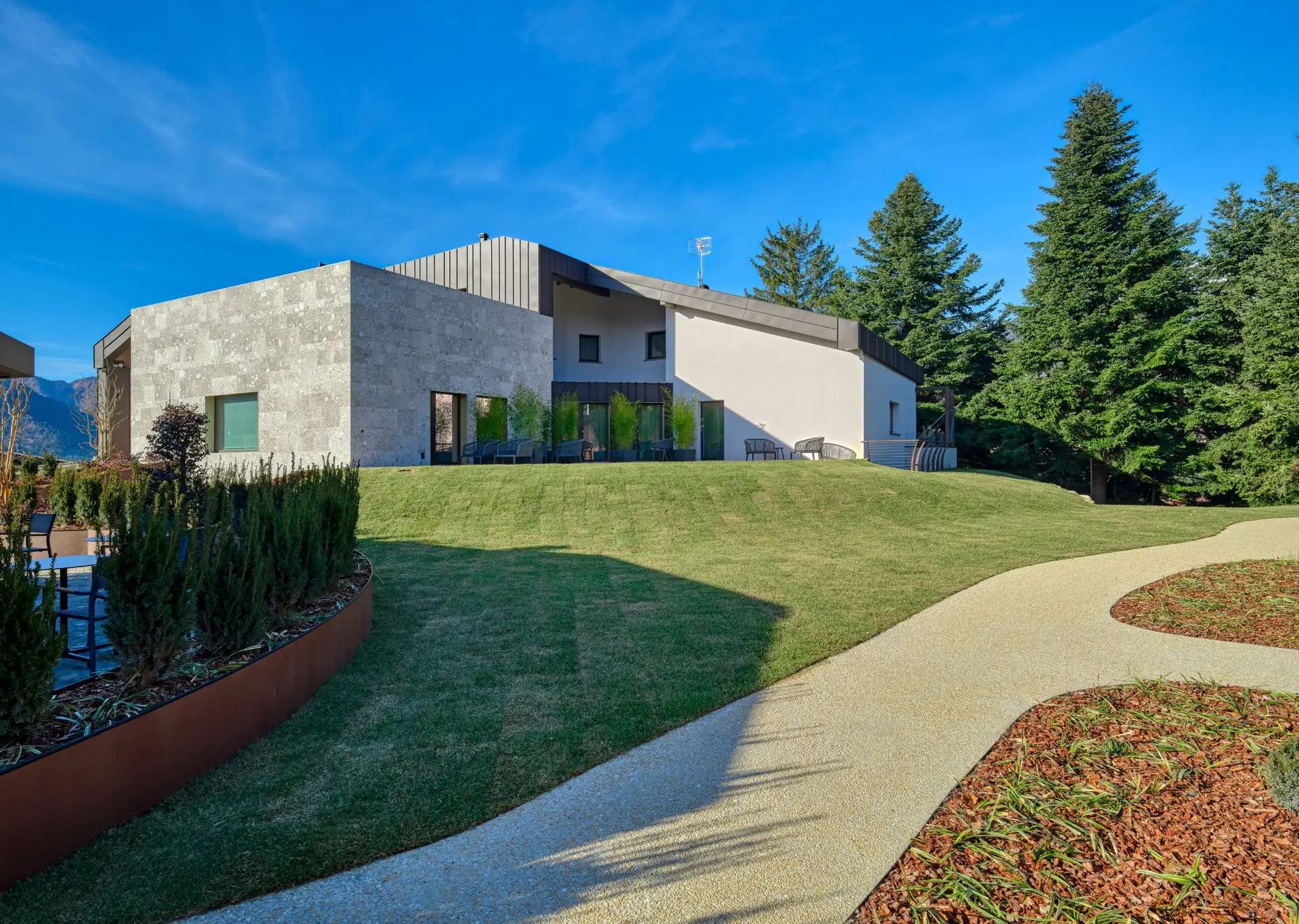 Villa principale con facciata in pietra, prato curato e sentiero nel parco — Collina Luxury Relais Clusone